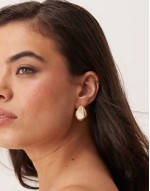 stud earrings with textured molten design in gold tone